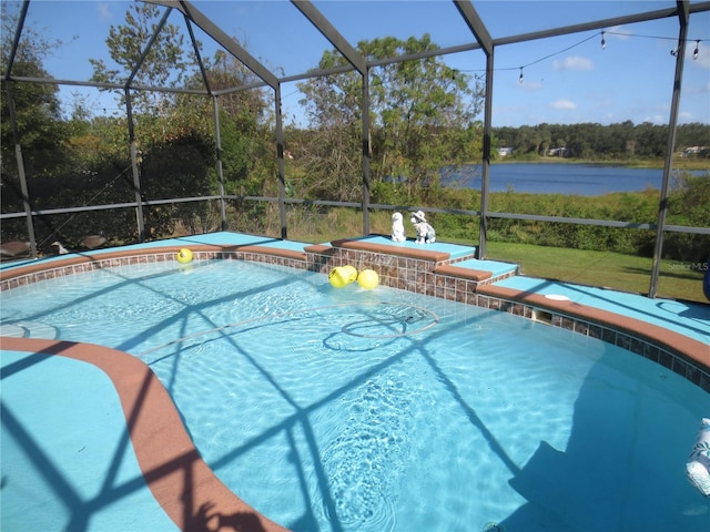 view of pool with a lanai and a water view