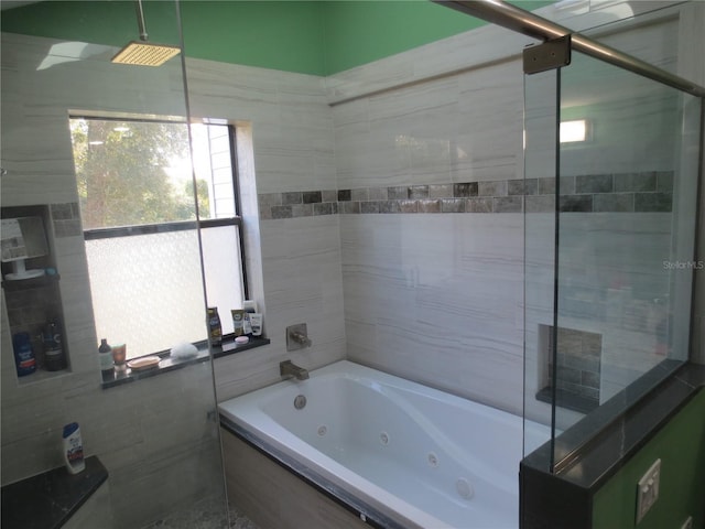 bathroom featuring shower with separate bathtub