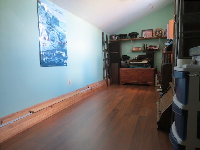 home office with dark wood-type flooring and vaulted ceiling