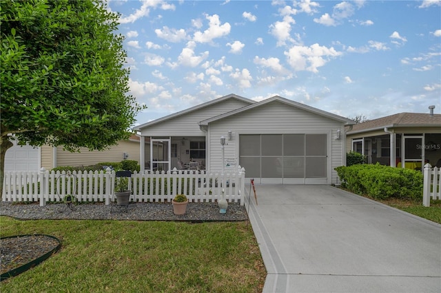 ranch-style home with a front lawn, a garage, and a sunroom