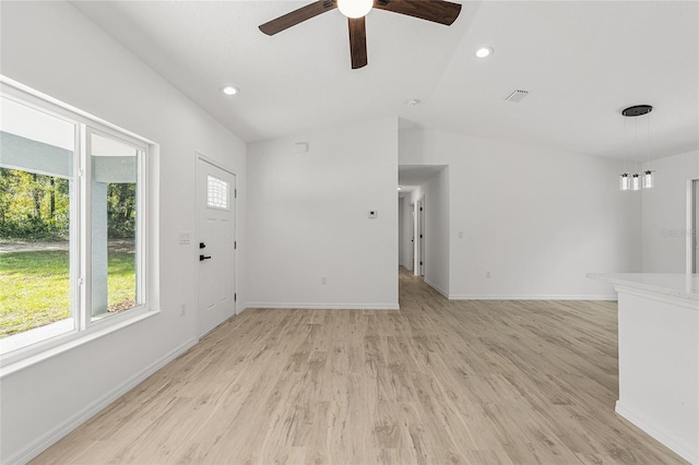 unfurnished living room with lofted ceiling, light wood-type flooring, and ceiling fan