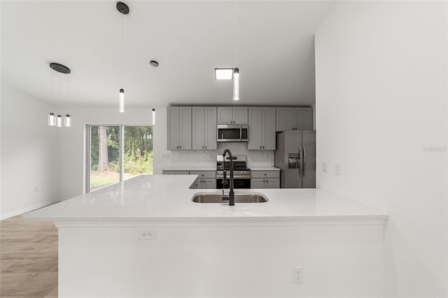 kitchen featuring pendant lighting, sink, and stainless steel appliances