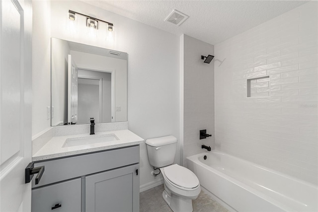 full bathroom featuring a textured ceiling, toilet, vanity, tiled shower / bath combo, and tile patterned flooring