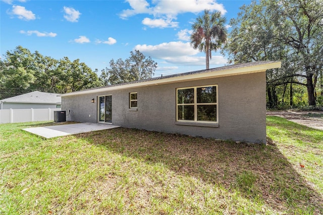 back of property featuring a yard, a patio area, and central AC unit