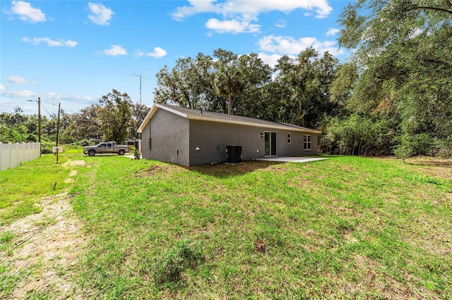 back of property featuring a patio, a lawn, and central AC unit