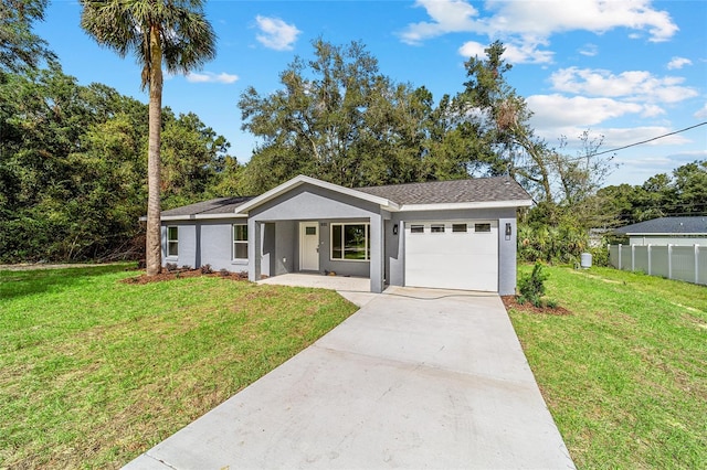 ranch-style home featuring a front lawn and a garage