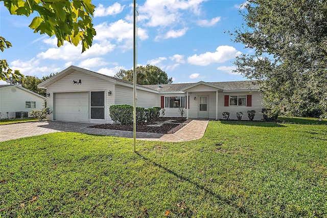 single story home with central air condition unit, a front lawn, and a garage