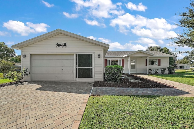 view of front of home with a front lawn and a garage