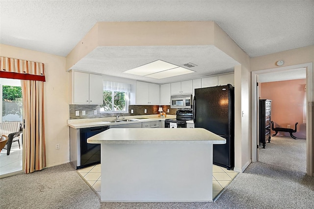 kitchen with light colored carpet, white cabinetry, black appliances, and a textured ceiling