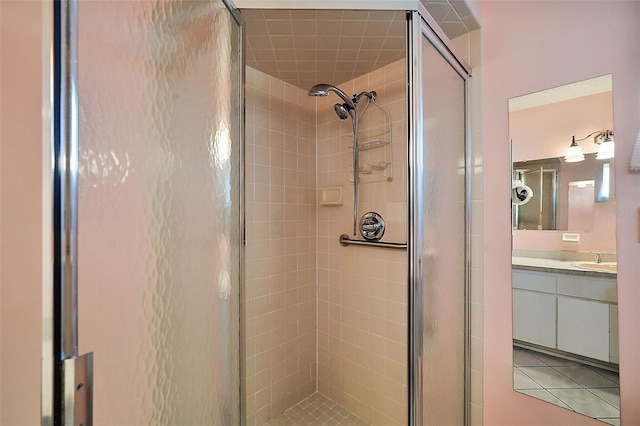 bathroom with vanity, tile patterned flooring, and an enclosed shower