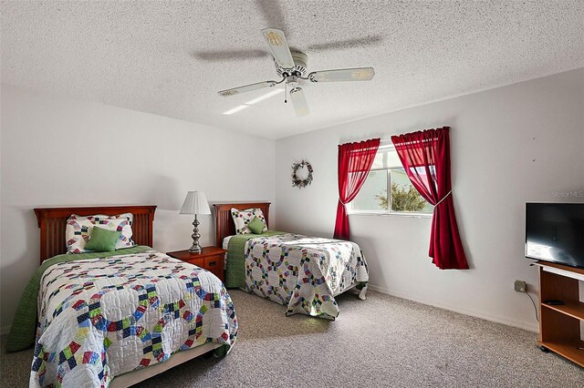 bedroom featuring ceiling fan, carpet flooring, and a textured ceiling