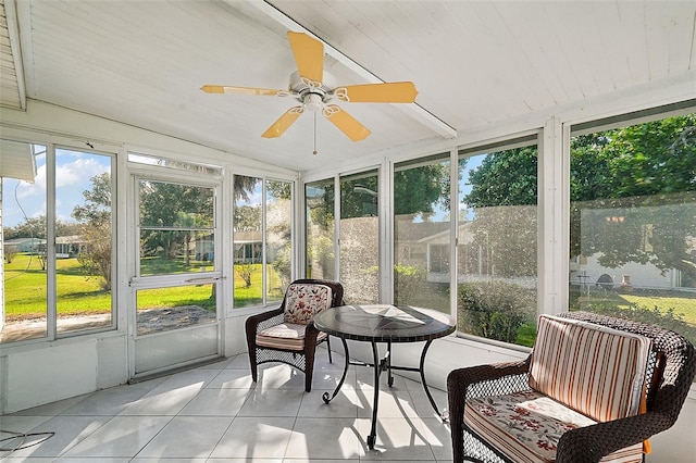 sunroom with lofted ceiling, wooden ceiling, and ceiling fan