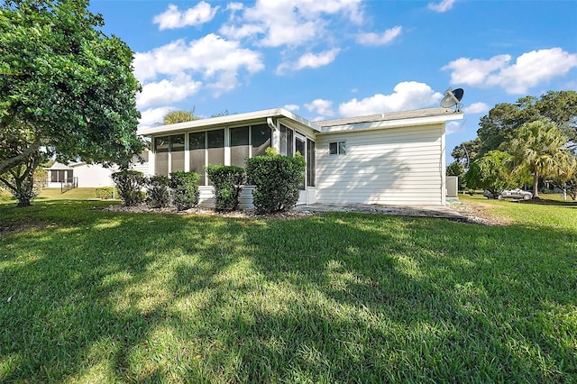 view of side of home featuring a lawn