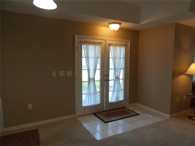 doorway to outside featuring french doors and light colored carpet