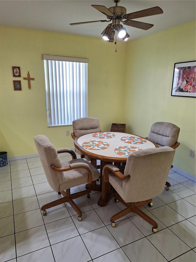 tiled dining space with ceiling fan