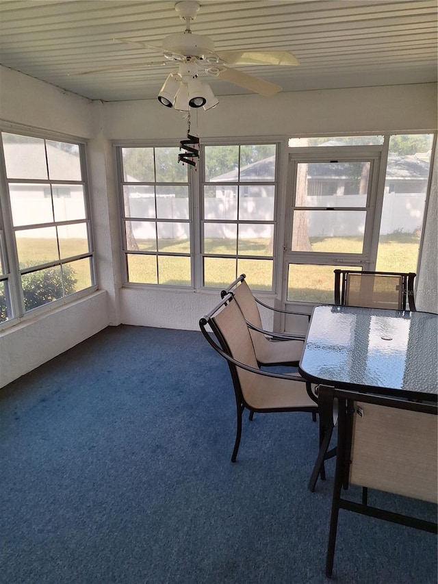 unfurnished sunroom featuring ceiling fan