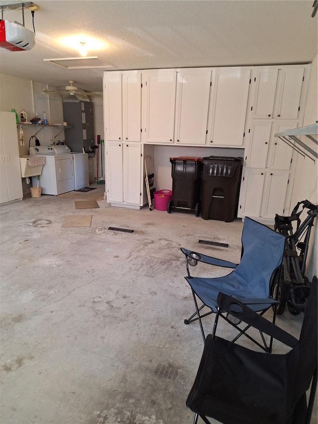 garage with a garage door opener and washer and dryer