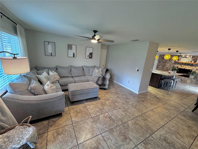 living room featuring light tile patterned flooring and ceiling fan