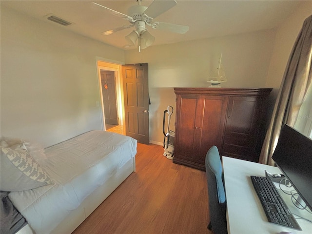 bedroom with ceiling fan and light hardwood / wood-style flooring