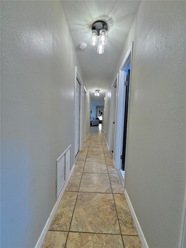 hallway featuring light tile patterned floors