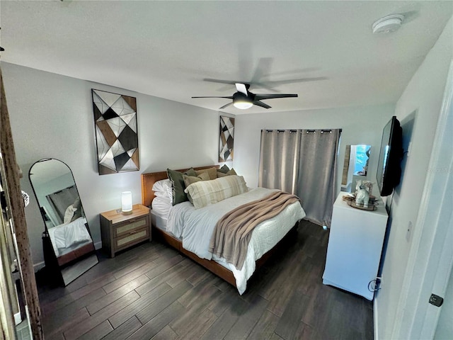 bedroom with ceiling fan and dark hardwood / wood-style flooring