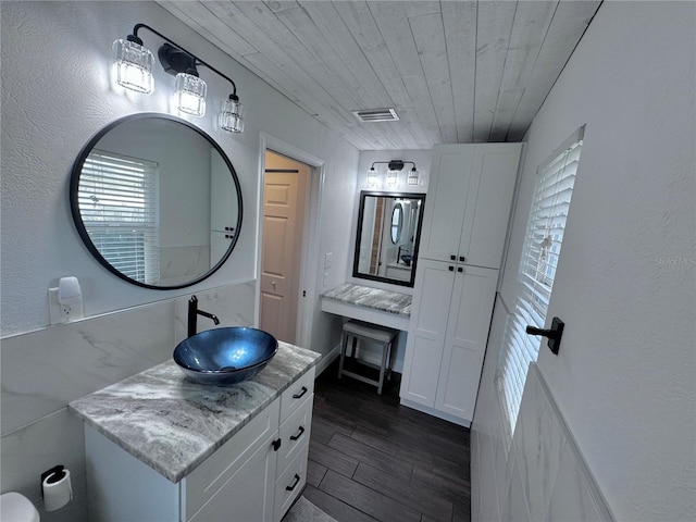 bathroom featuring wood-type flooring, wooden ceiling, and vanity