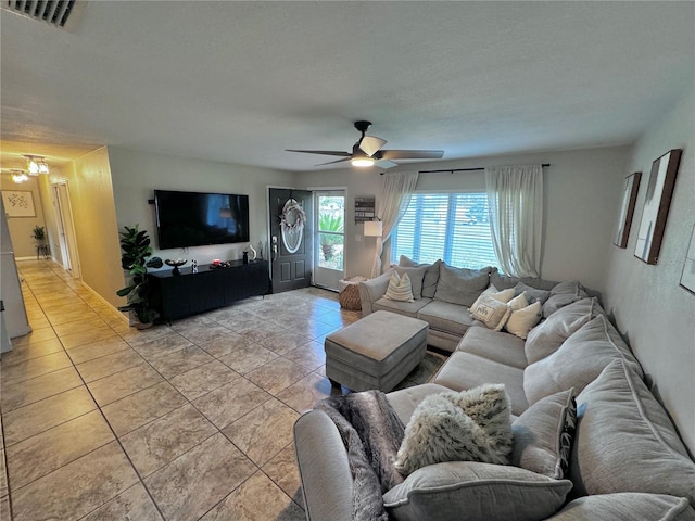 tiled living room featuring ceiling fan