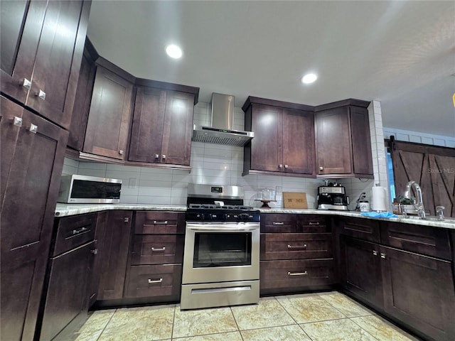 730 NE 18th Ave, Ocala, FL 34470 - kitchen featuring a sink, stainless steel appliances, wall chimney exhaust hood, dark brown cabinetry, and decorative backsplash