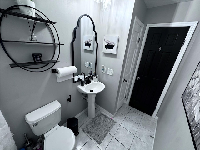 bathroom with tile patterned flooring and toilet