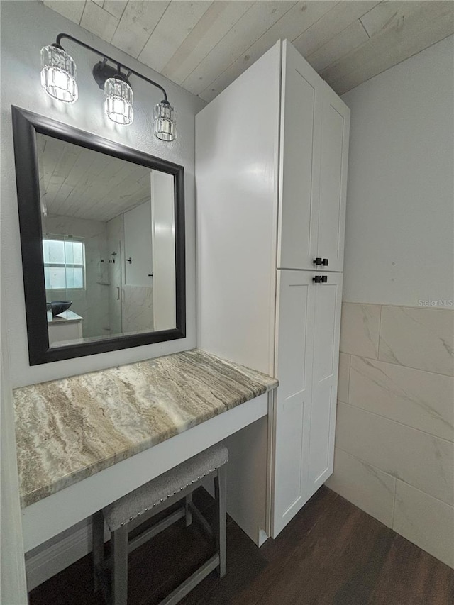 bathroom with hardwood / wood-style flooring, walk in shower, tile walls, and wooden ceiling