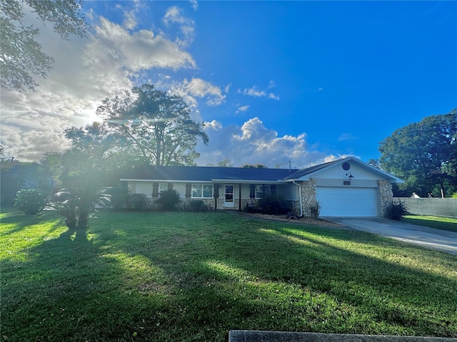 730 NE 18th Ave, Ocala, FL 34470 - ranch-style house featuring stone siding, an attached garage, driveway, and a front yard
