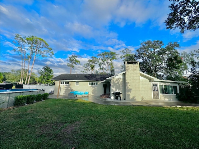 back of property featuring a yard and a patio