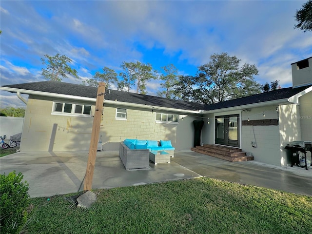 rear view of property featuring an outdoor hangout area and a patio