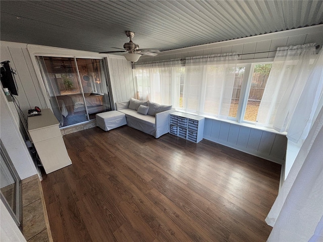 unfurnished sunroom with ceiling fan