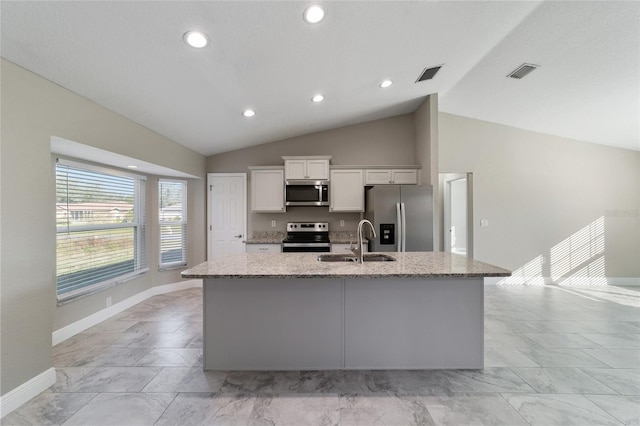 kitchen featuring sink, stainless steel appliances, vaulted ceiling, and white cabinets