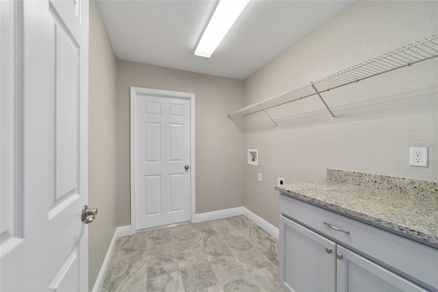 washroom featuring a textured ceiling, washer hookup, and electric dryer hookup