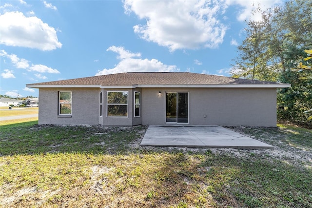 rear view of property featuring a patio and a lawn