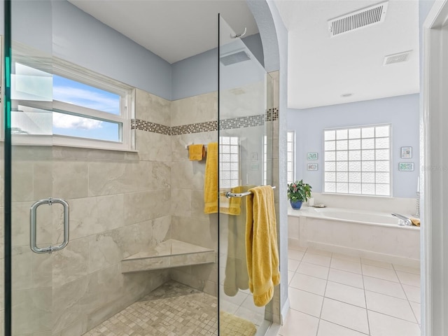 bathroom featuring tile patterned floors, a wealth of natural light, and independent shower and bath