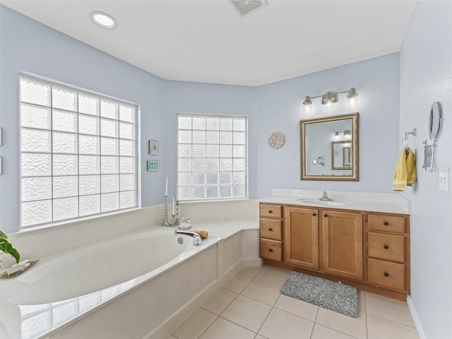 bathroom featuring vanity, a tub to relax in, and tile patterned floors