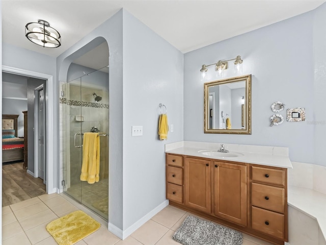 bathroom with tile patterned flooring, vanity, and an enclosed shower