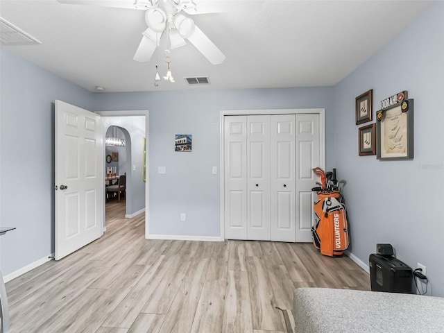 bedroom with a closet, ceiling fan, and light hardwood / wood-style floors