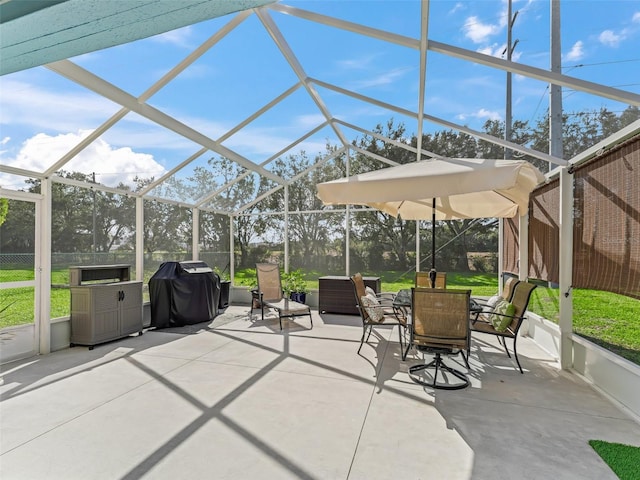 view of patio / terrace featuring area for grilling and glass enclosure