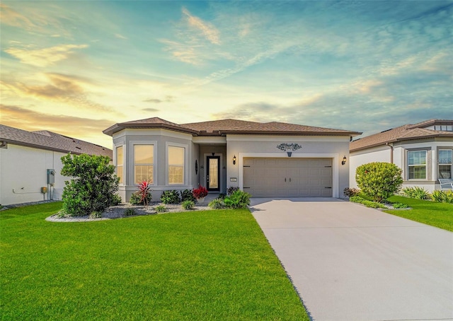 view of front of property with a lawn and a garage