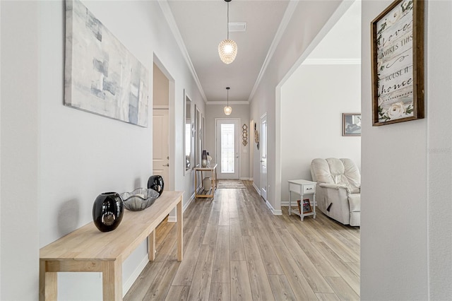 hall featuring light wood-type flooring and ornamental molding