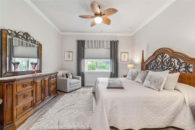 bedroom featuring ceiling fan, light wood-type flooring, and ornamental molding