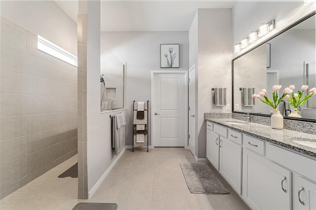 bathroom with vanity, tile patterned floors, and tiled shower