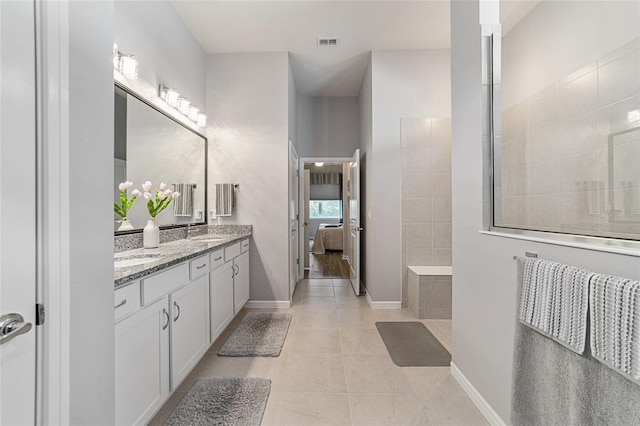 bathroom with tile patterned flooring and vanity