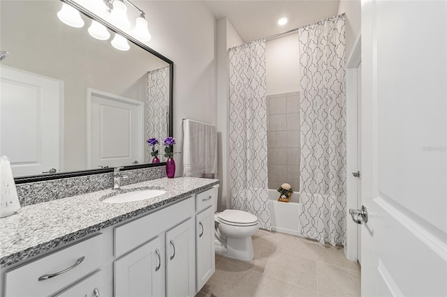 full bathroom with shower / bath combo with shower curtain, tile patterned floors, vanity, and toilet