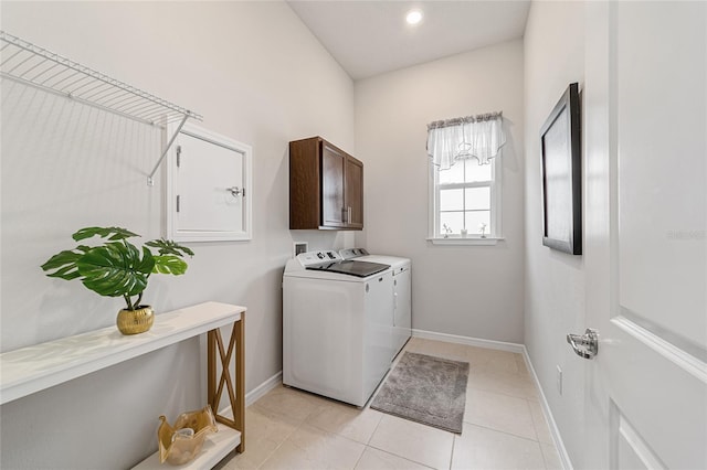 laundry area featuring cabinets, separate washer and dryer, and light tile patterned floors