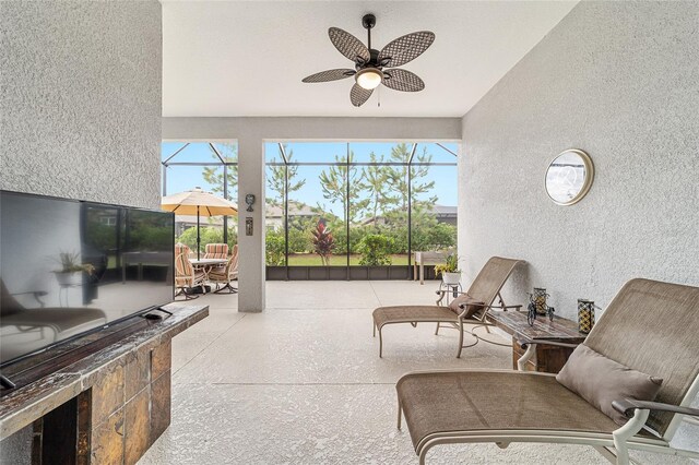 sunroom featuring ceiling fan